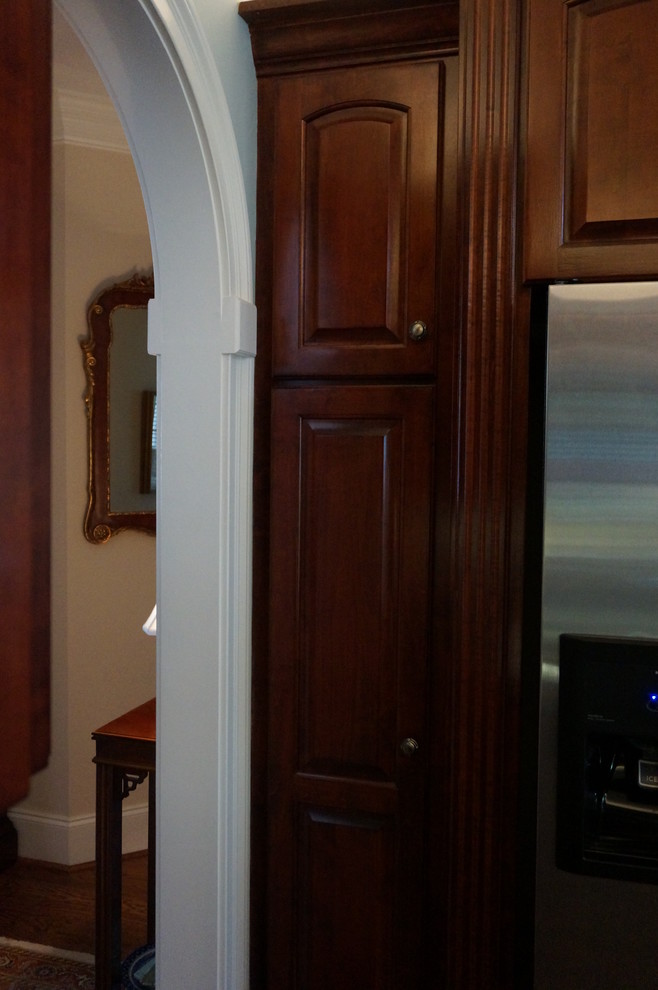 Inspiration for a large transitional u-shaped eat-in kitchen remodel with raised-panel cabinets, granite countertops and an island