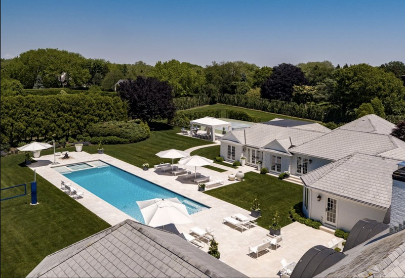 Large backyard stone and rectangular lap hot tub photo in New York