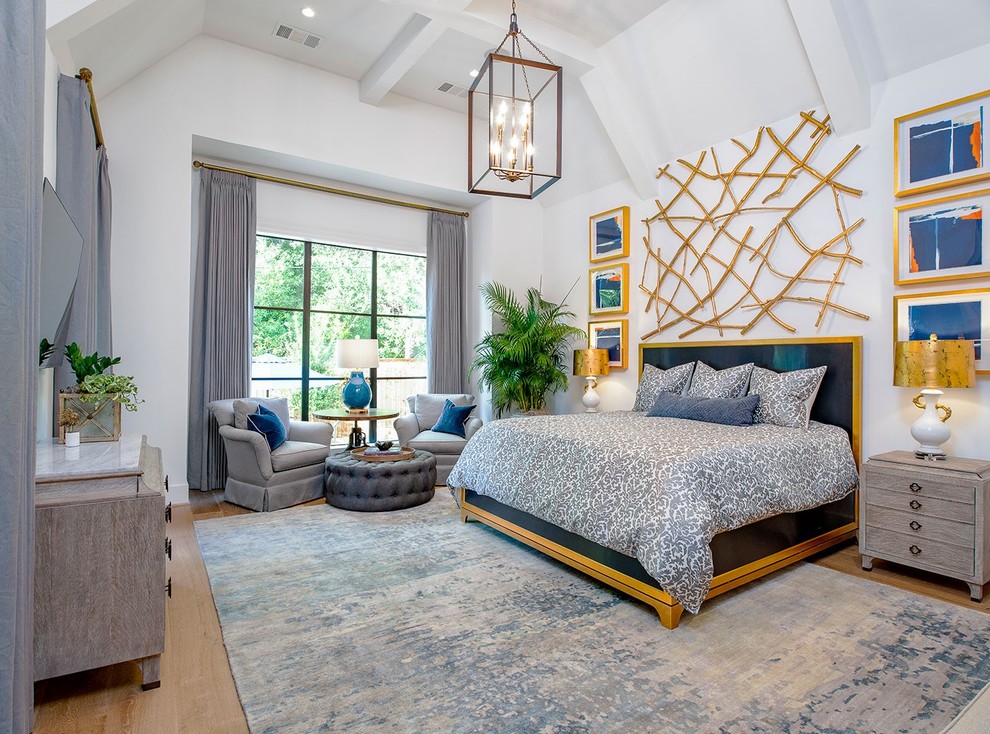 Transitional bedroom in Houston with white walls, medium hardwood floors and brown floor.