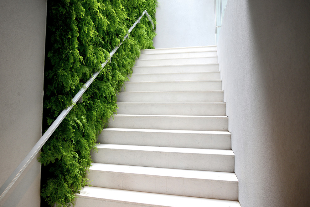 This is an example of a mid-sized modern concrete straight staircase in Atlanta with concrete risers.