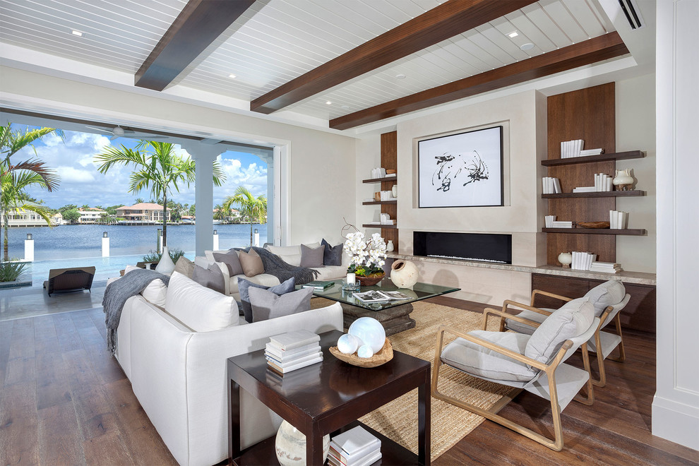 Photo of a mid-sized beach style formal open concept living room in Other with white walls, medium hardwood floors, a ribbon fireplace, a tile fireplace surround, no tv and brown floor.