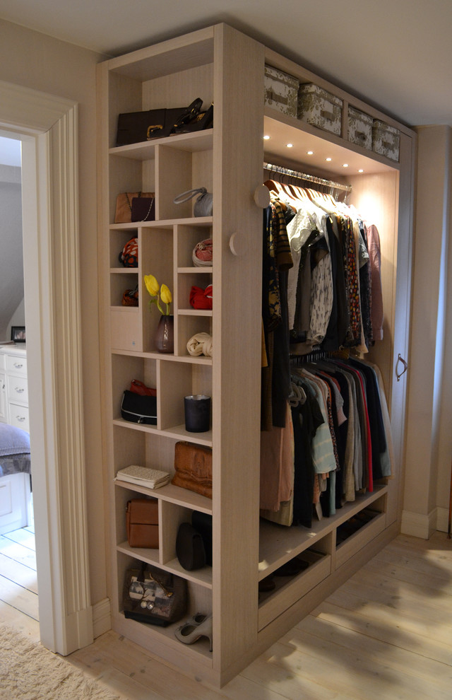 Design ideas for a transitional gender-neutral dressing room in Hamburg with open cabinets and painted wood floors.