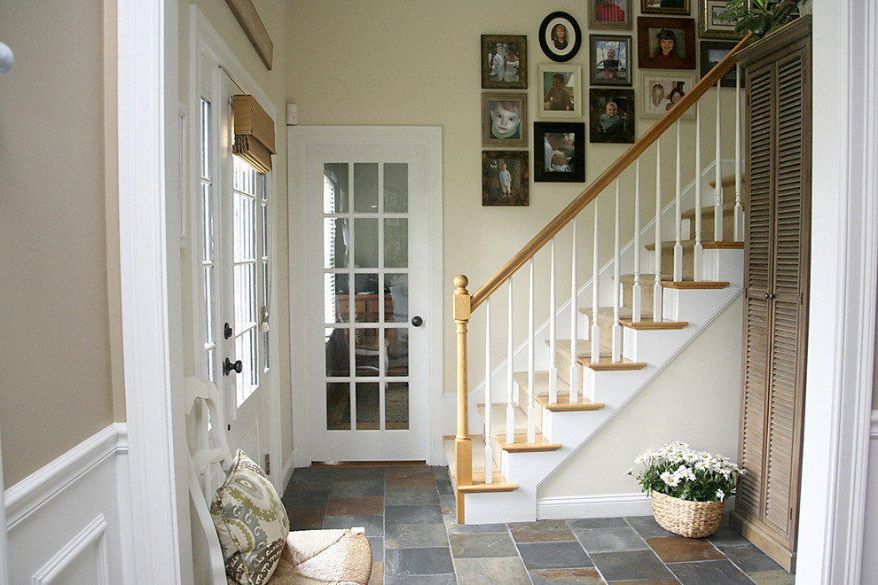 This is an example of a large beach style foyer in Boston with slate floors, beige walls, a single front door and a white front door.