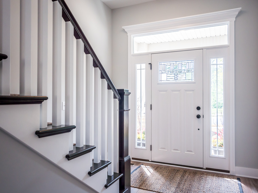 Mid-sized arts and crafts foyer in Other with grey walls, medium hardwood floors, a single front door and a white front door.