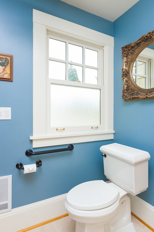 Mid-sized traditional powder room in Portland with furniture-like cabinets, medium wood cabinets, a two-piece toilet, yellow tile, ceramic tile, blue walls, porcelain floors, an undermount sink and granite benchtops.