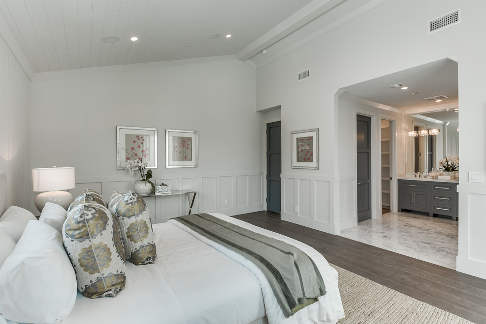 Photo of a large contemporary master bedroom in Los Angeles with white walls, medium hardwood floors and brown floor.