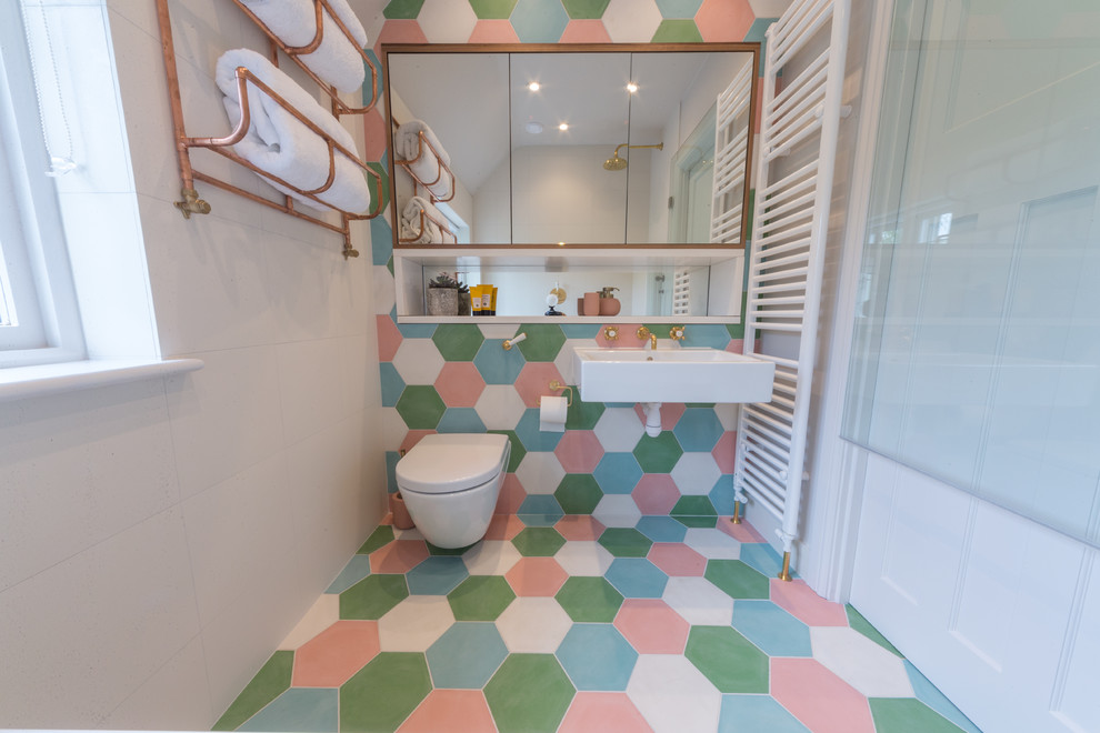 Eclectic 3/4 wet room bathroom in Other with a wall-mount toilet, blue tile, green tile, pink tile, white tile, cement tile, grey walls, cement tiles, a wall-mount sink and multi-coloured floor.