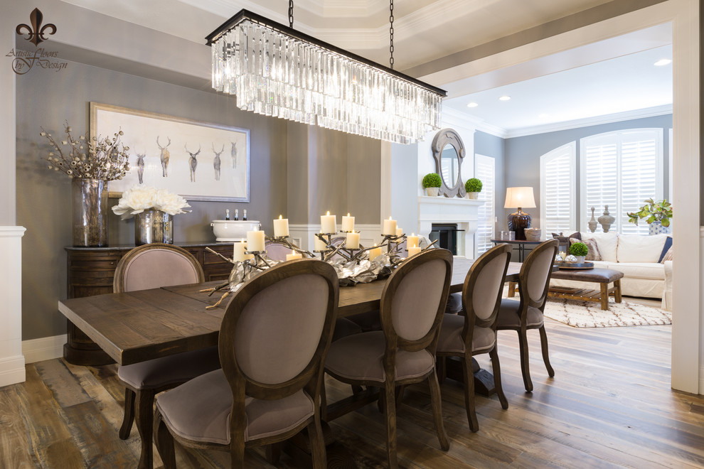 Design ideas for an expansive transitional open plan dining in Denver with dark hardwood floors, a standard fireplace, a plaster fireplace surround and multi-coloured floor.