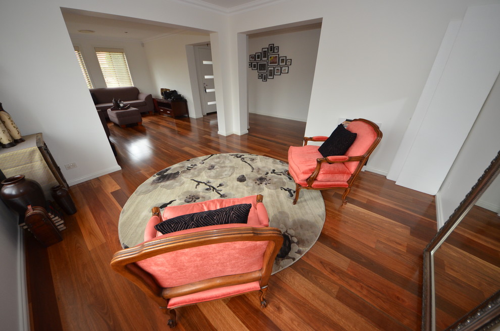 Photo of a mid-sized transitional enclosed family room in Sydney with white walls and no tv.