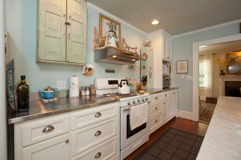 Design ideas for a traditional galley kitchen in Wilmington with white cabinets and white appliances.