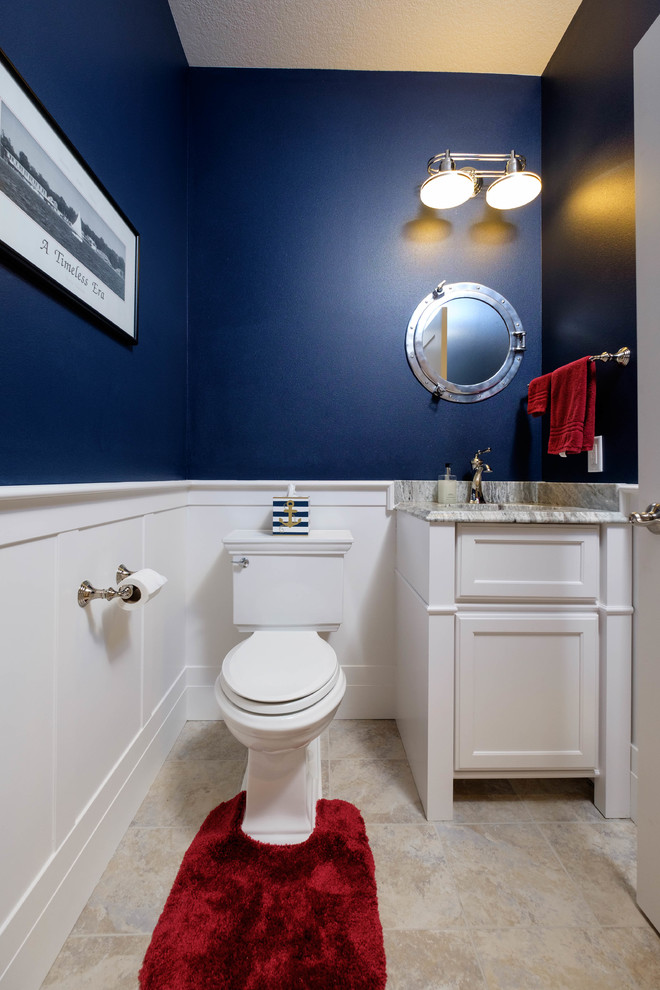 Design ideas for a small transitional powder room in Other with recessed-panel cabinets, white cabinets, a two-piece toilet, white tile, stone tile, blue walls, travertine floors, an undermount sink and granite benchtops.