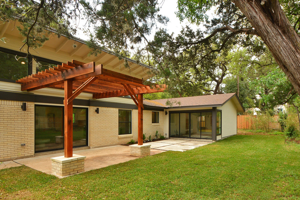 Design ideas for a large modern one-storey brick green exterior in Austin.