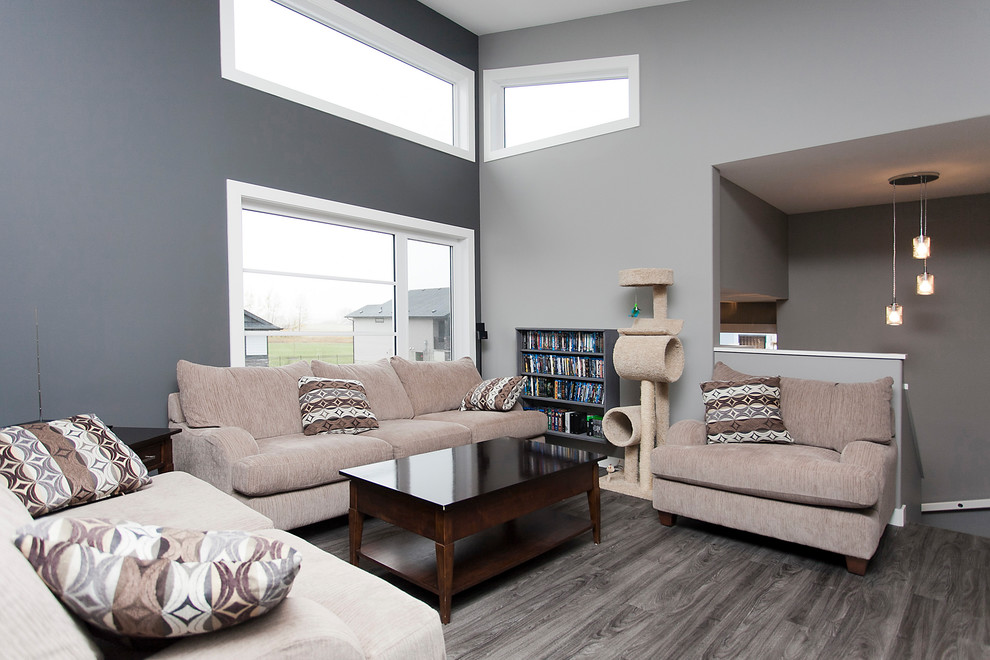 Design ideas for a mid-sized transitional open concept living room in Calgary with grey walls, vinyl floors, no fireplace, a wall-mounted tv and brown floor.