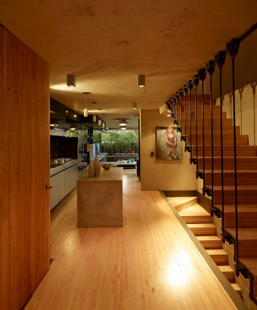 Design ideas for a small industrial foyer in Sydney with brown walls, light hardwood floors, a single front door, a medium wood front door and beige floor.