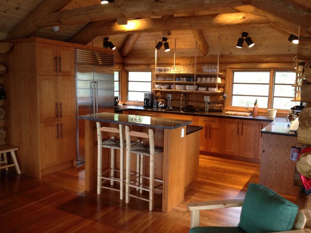 Open concept kitchen - mid-sized rustic u-shaped medium tone wood floor open concept kitchen idea in Toronto with shaker cabinets, medium tone wood cabinets, quartzite countertops, stainless steel appliances, an island, an undermount sink and brown backsplash