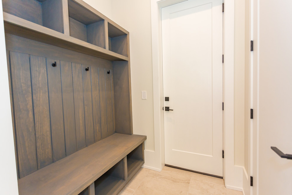 Photo of a small transitional mudroom in Orlando with beige walls, porcelain floors, a single front door, a white front door and beige floor.