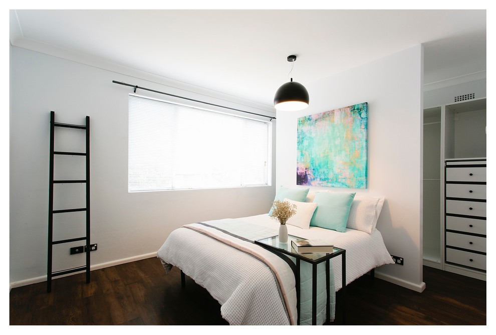 Photo of a mid-sized master bedroom in Sydney with white walls and linoleum floors.