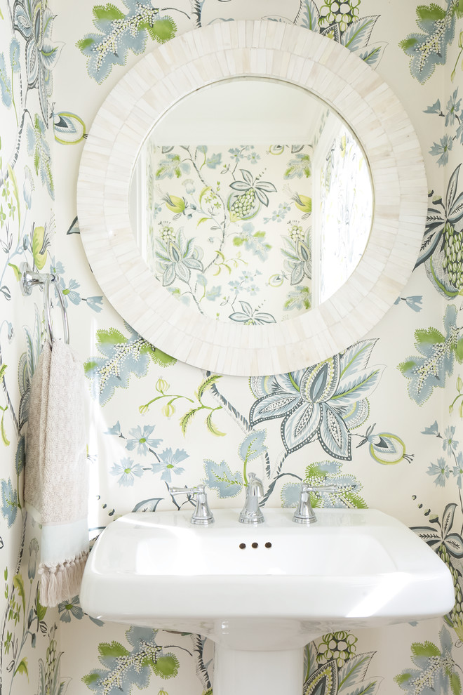 Inspiration for a beach style powder room in Milwaukee with multi-coloured walls and a pedestal sink.
