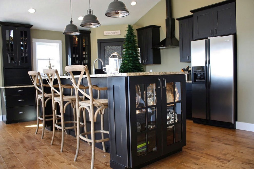 Kitchen - mid-sized l-shaped light wood floor kitchen idea in Chicago with an undermount sink, shaker cabinets, black cabinets, granite countertops, stainless steel appliances and an island