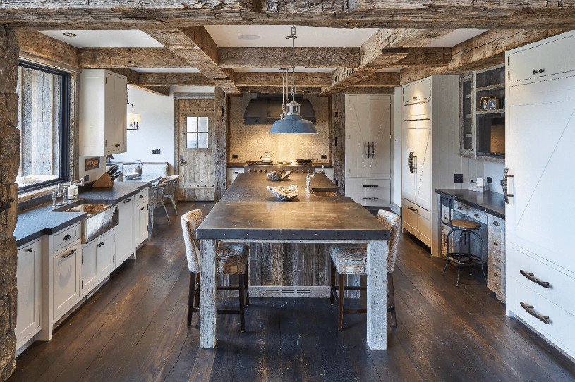 Eat-in kitchen - mid-sized rustic u-shaped dark wood floor and brown floor eat-in kitchen idea with a farmhouse sink, recessed-panel cabinets, white cabinets, quartz countertops, paneled appliances, an island and gray countertops
