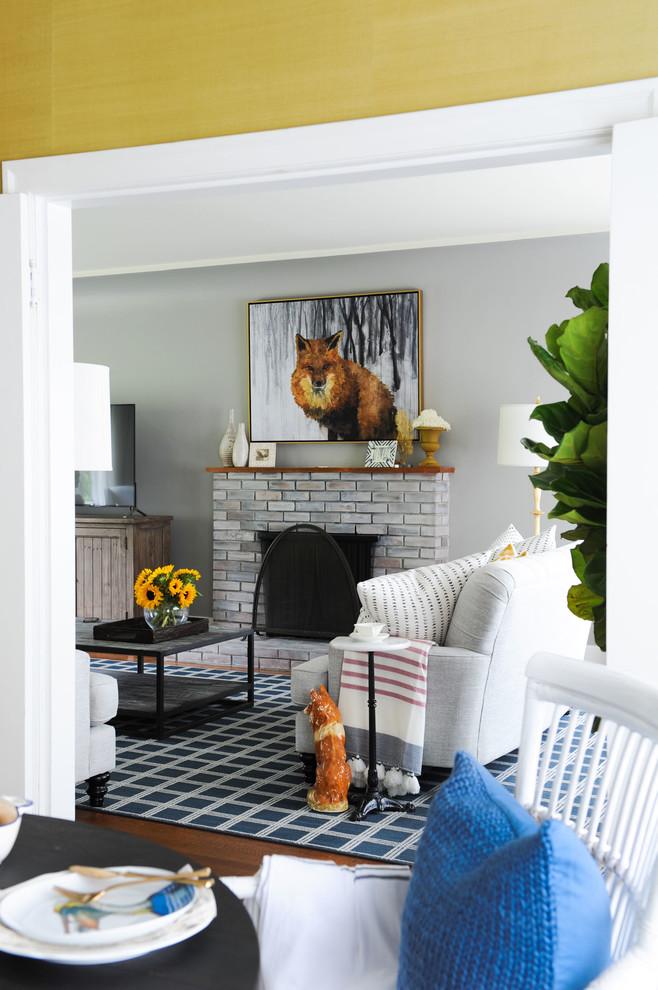 Inspiration for a transitional medium tone wood floor and brown floor dining room remodel with yellow walls
