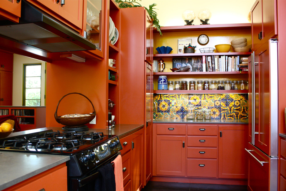 This is an example of a galley separate kitchen in Santa Barbara with open cabinets, orange cabinets, multi-coloured splashback and panelled appliances.