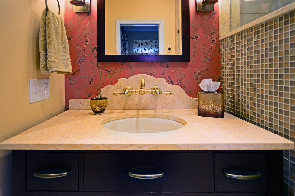 Photo of an eclectic bathroom in Philadelphia with flat-panel cabinets, dark wood cabinets, limestone benchtops, multi-coloured tile, glass sheet wall, an undermount sink, multi-coloured walls and porcelain floors.