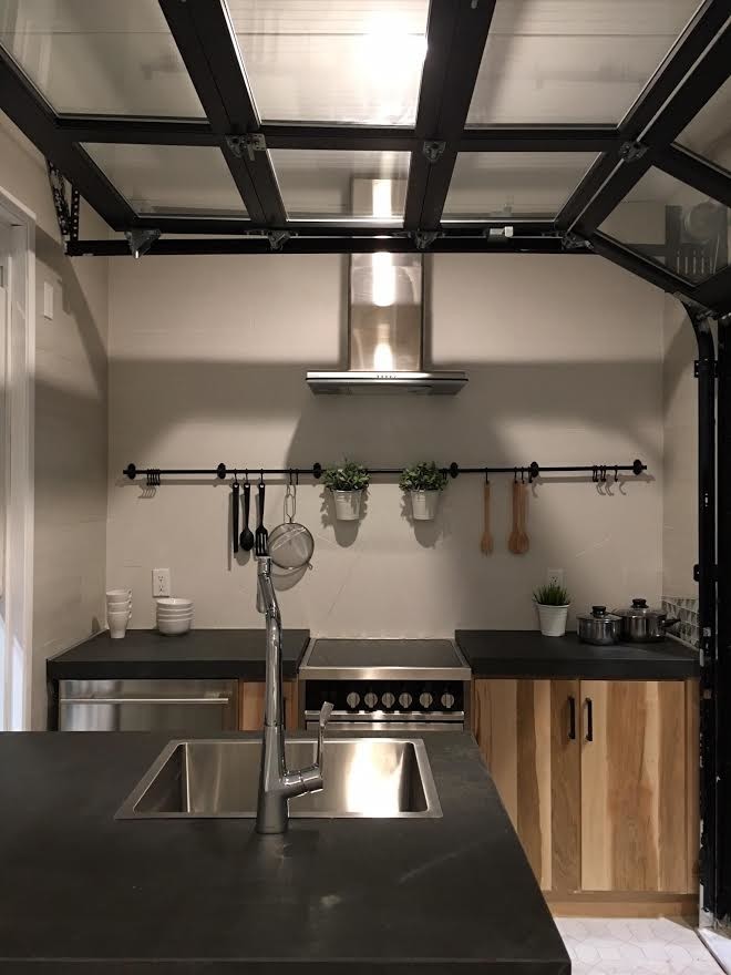 Inspiration for a small transitional galley porcelain tile and beige floor open concept kitchen remodel in Tampa with flat-panel cabinets, light wood cabinets, solid surface countertops, stainless steel appliances and a peninsula