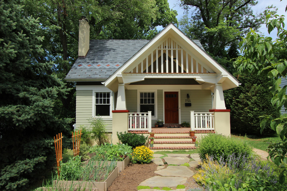 Small arts and crafts two-storey green exterior in DC Metro with wood siding and a gable roof.