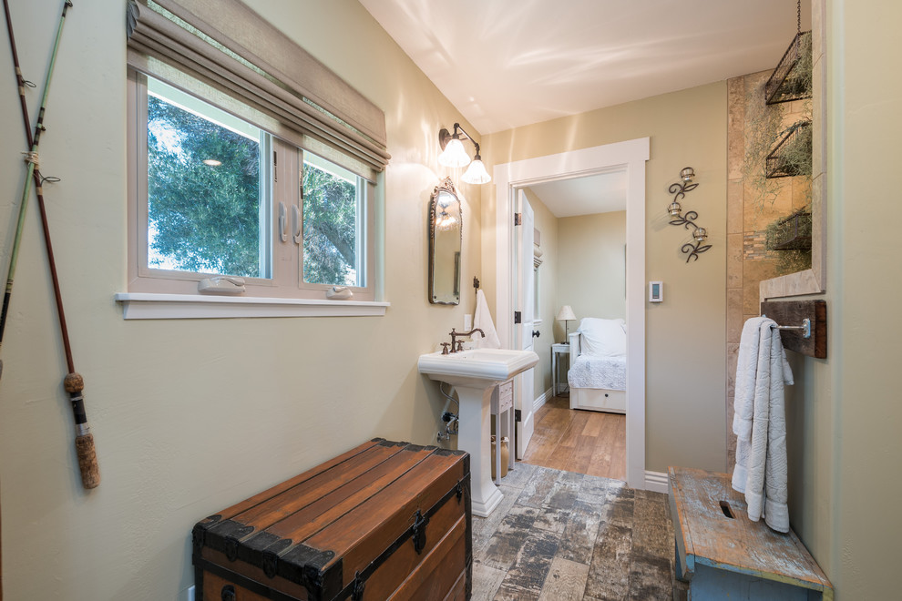 Mid-sized country bathroom in Santa Barbara with an open shower, beige tile, porcelain tile, beige walls, medium hardwood floors and a pedestal sink.