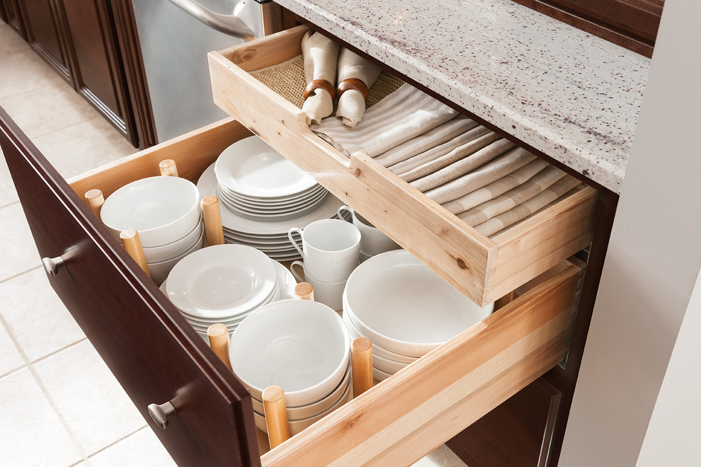 Inspiration for a limestone floor kitchen remodel in DC Metro with raised-panel cabinets, dark wood cabinets, quartz countertops and stainless steel appliances