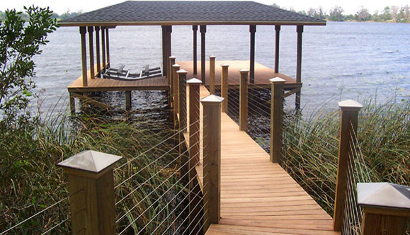 This is an example of a mid-sized transitional backyard deck in Orlando with with dock.