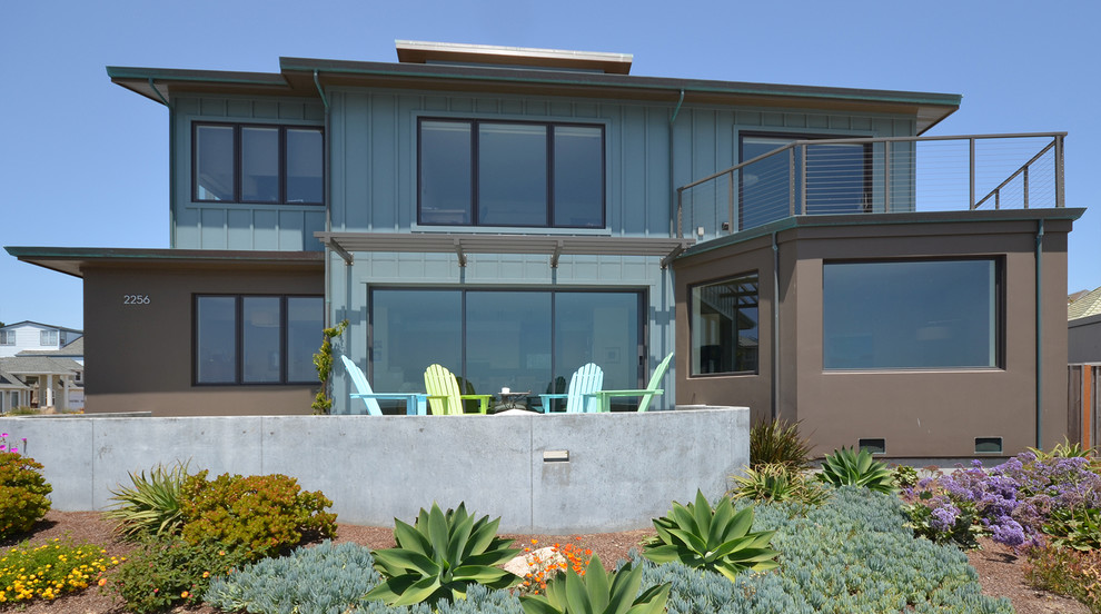 This is an example of a beach style two-storey blue exterior in San Francisco with mixed siding.