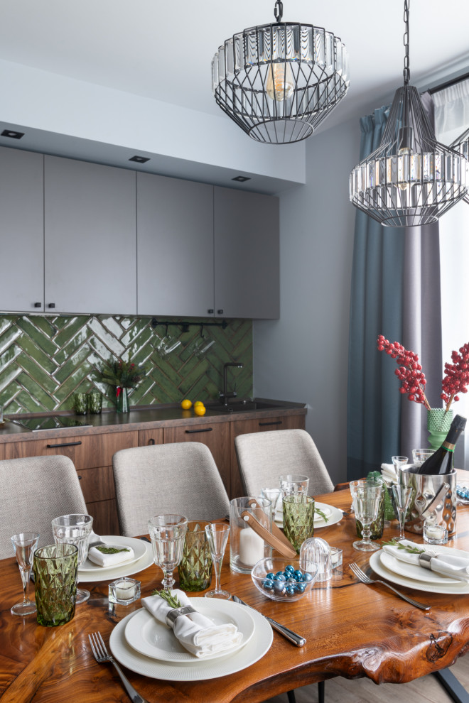 Mid-sized contemporary single-wall eat-in kitchen in Moscow with an undermount sink, flat-panel cabinets, dark wood cabinets, laminate benchtops, green splashback, ceramic splashback, black appliances, porcelain floors, no island, grey floor and brown benchtop.