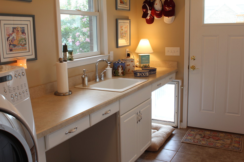 Inspiration for a traditional laundry room in Other with a drop-in sink and beige walls.