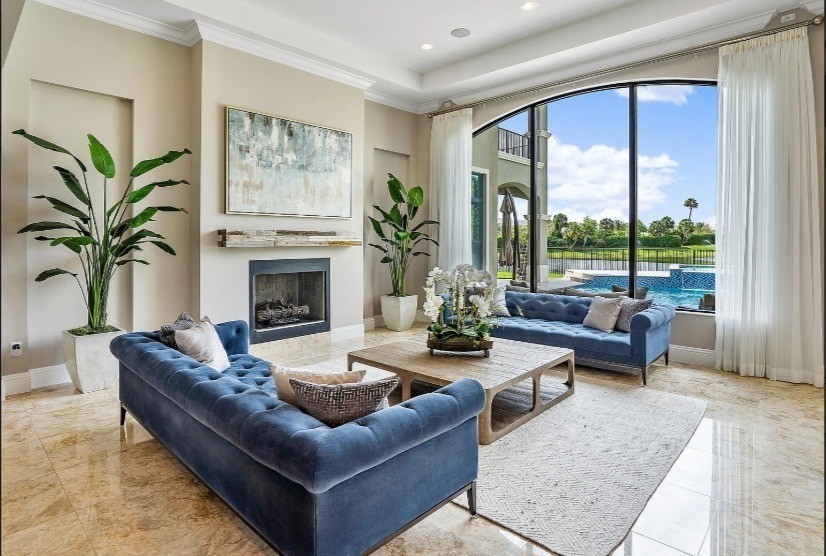 Inspiration for a large country formal open concept living room in Miami with beige walls, marble floors, a standard fireplace, a wood fireplace surround and beige floor.