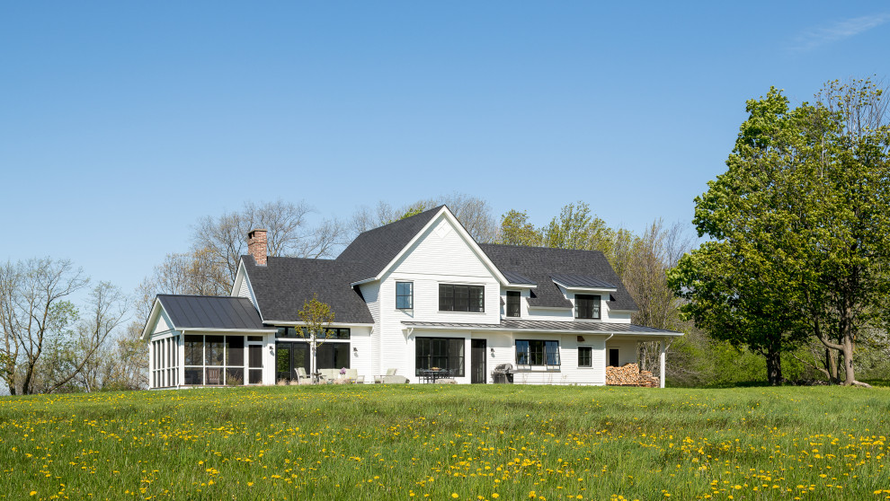 Mid-sized country two-storey white house exterior in Burlington with wood siding, a gable roof, a shingle roof, a grey roof and board and batten siding.