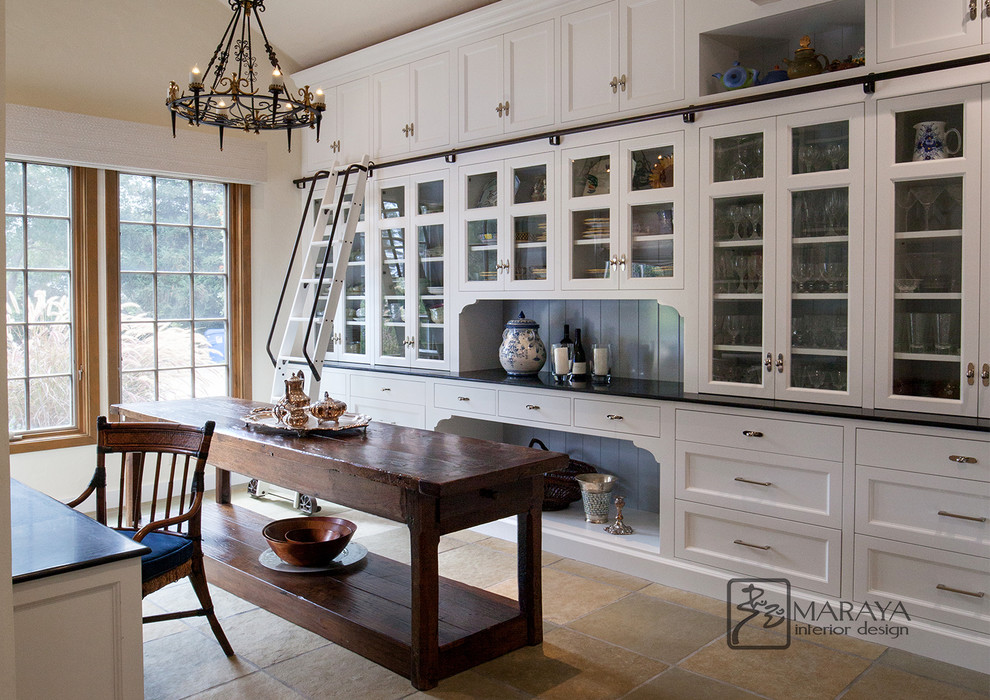Inspiration for a large traditional u-shaped kitchen pantry in Santa Barbara with glass-front cabinets, white cabinets, soapstone benchtops, slate floors, with island, green floor and black benchtop.