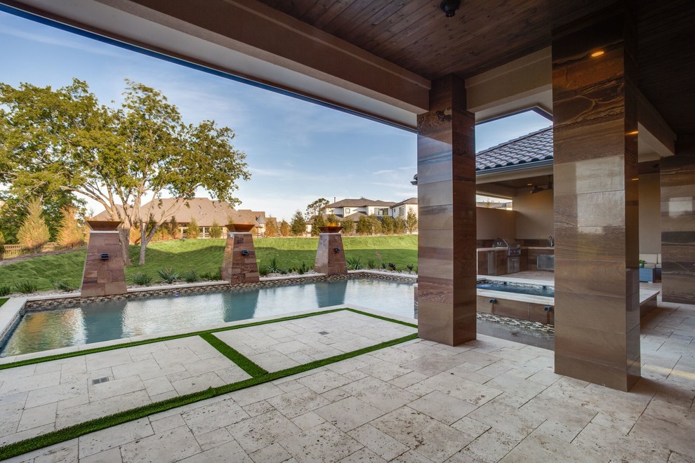 Design ideas for a large transitional backyard rectangular lap pool in Dallas with natural stone pavers.