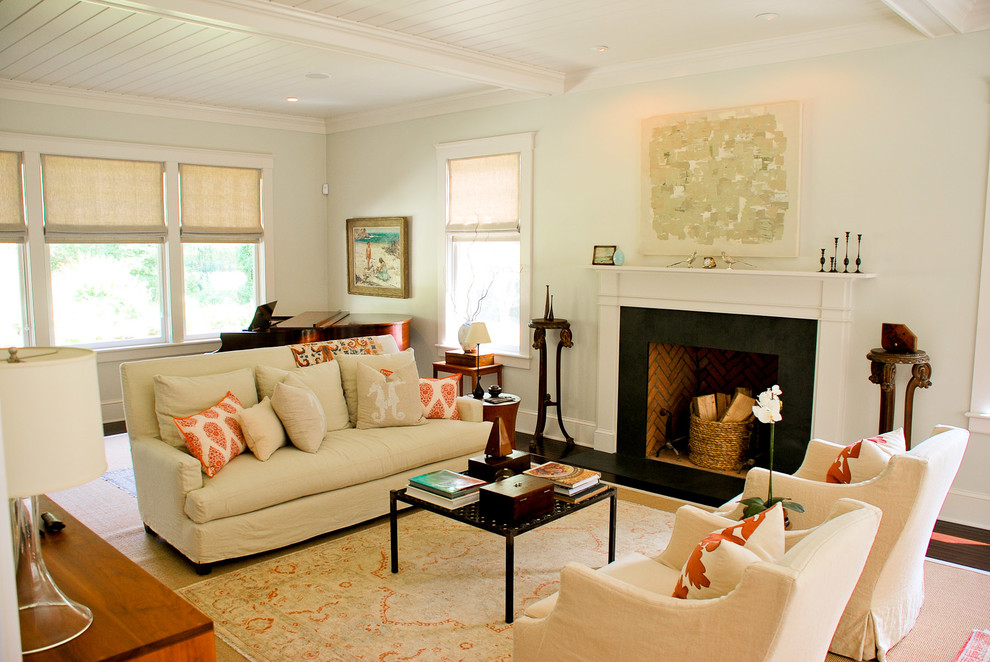 This is an example of a traditional formal enclosed living room in Boston with white walls, a standard fireplace and a metal fireplace surround.