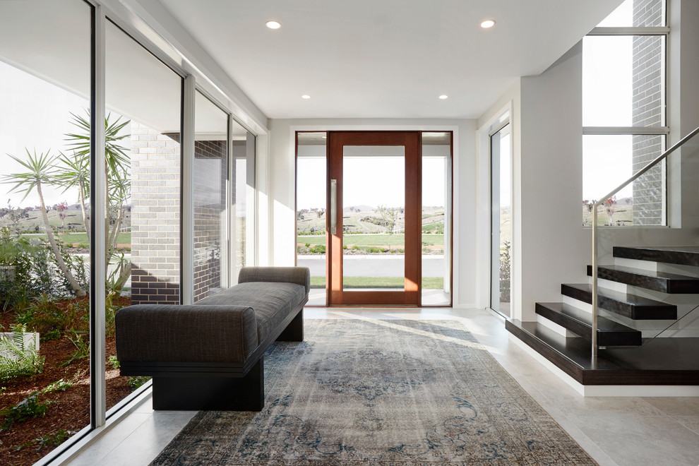 Contemporary foyer in Sydney with white walls, a single front door, a glass front door and grey floor.