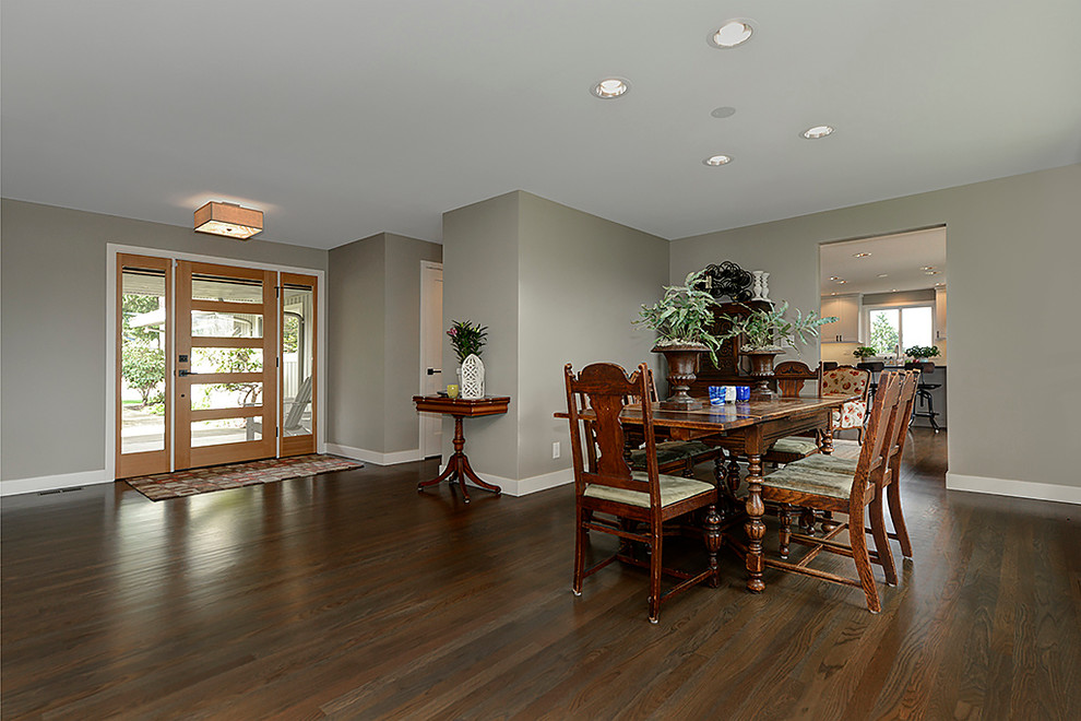 Transitional dining room in Seattle with grey walls and dark hardwood floors.