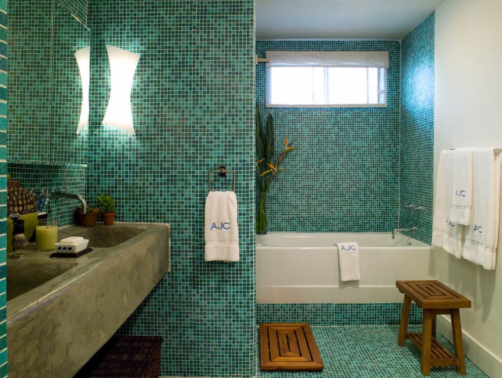 This is an example of a mid-sized eclectic master bathroom in Los Angeles with a freestanding tub, a corner shower, gray tile, mosaic tile, blue walls, mosaic tile floors, a trough sink, concrete benchtops, blue floor and a shower curtain.