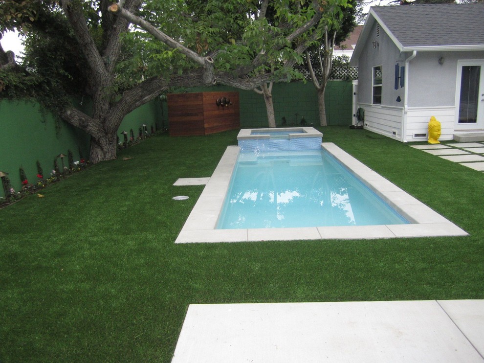 Photo of a small modern backyard rectangular pool in Los Angeles with a hot tub and concrete pavers.