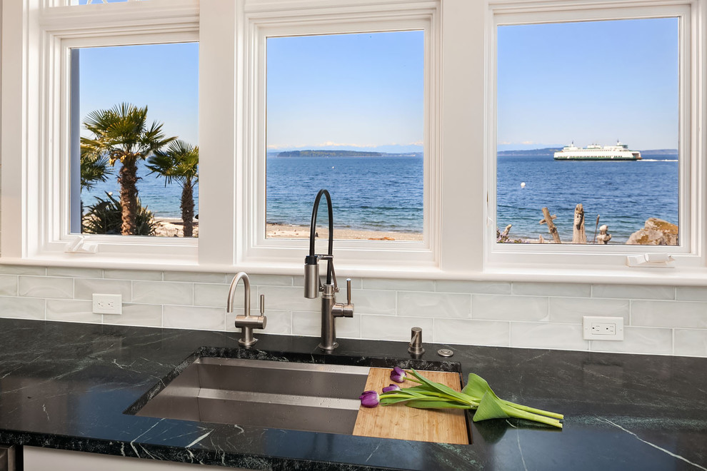 Design ideas for a large beach style open plan kitchen in Seattle with an undermount sink, shaker cabinets, soapstone benchtops, glass tile splashback, stainless steel appliances, slate floors, with island, green floor and green benchtop.
