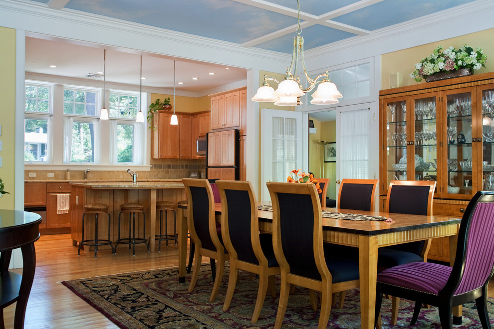 This is an example of a mid-sized traditional open plan dining in Boston with yellow walls, light hardwood floors and no fireplace.