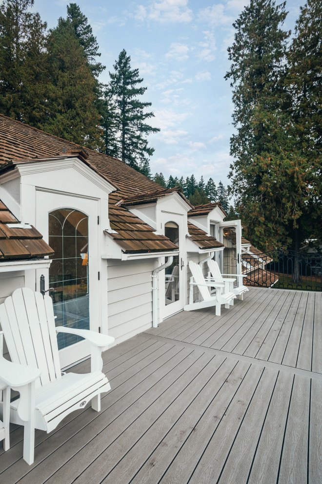 Photo of an expansive and white eclectic two floor detached house in Vancouver with vinyl cladding, a half-hip roof, a shingle roof and a brown roof.