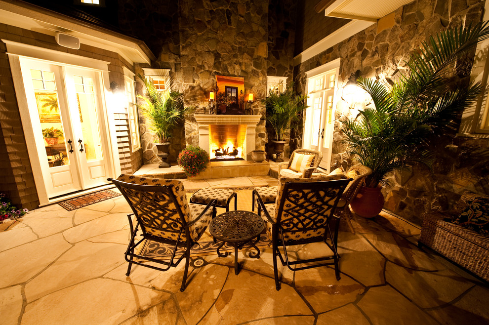 Inspiration for a small traditional courtyard patio in Denver with a fire feature, natural stone pavers and no cover.