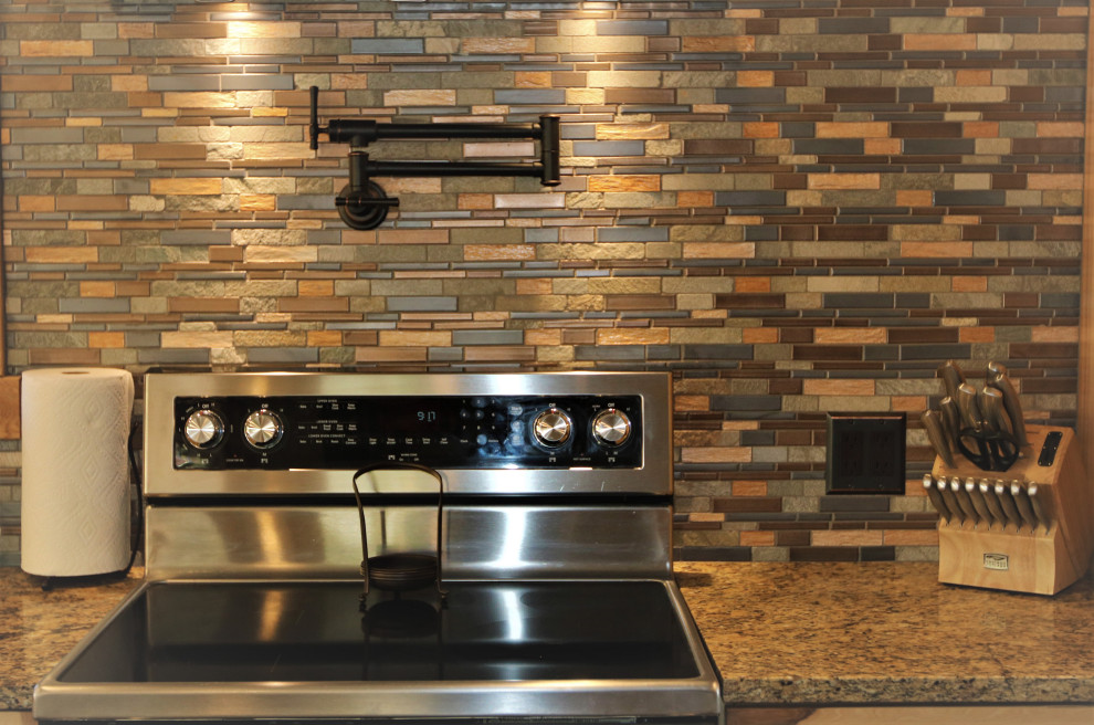 Kitchen - large rustic kitchen idea with granite countertops and stone tile backsplash