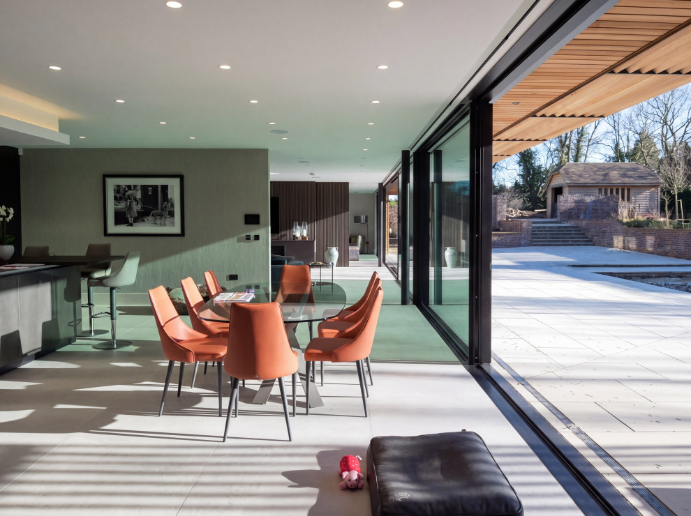 Large gray floor kitchen/dining room combo photo with gray walls